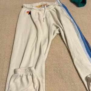Aviator Nation cream sweatpants with 5 stipe blue ombré on the side